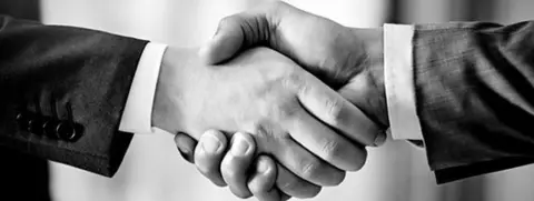 Generic image showing two men in suits shaking hands
