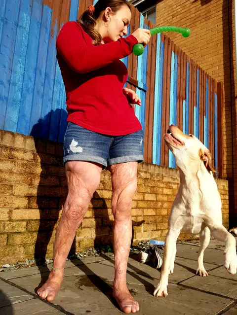 Ena Miller Laura plays with her dog