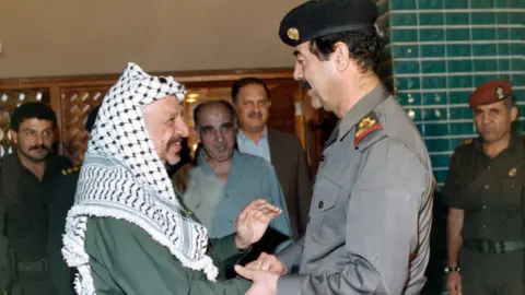 Getty Images Yasser Arafat (left) with Saddam Hussein (file photo)