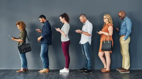 Getty Images People standing in a queue