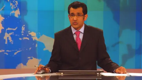 Barry Iverson / Alamy Stock Photo Al Jazeera English anchor delivering the news at the Doha HQ of AJE - Alamy