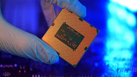 Getty Images Close-up gloved hands holding detail microchip