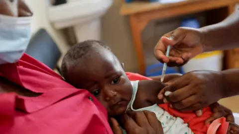 Reuters A nurse administers the malaria vaccine to an infant at the Lumumba Sub-County hospital in Kisumu, Kenya, July 1, 2022.