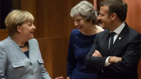 AFP Angela Merkel (l), Theresa May and Emmanuel Macron