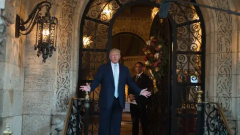 Getty Images Trump - standing in front of his Mar-a-Lago estate