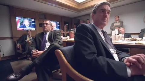 US National Archives Then-CIA director George Tenant and FBI director Robert Mueller in the White House security area on 9/11