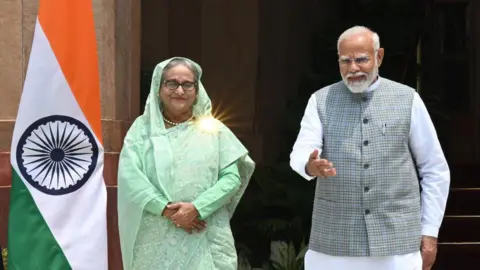 Getty Images Prime Minister Narendra Modi and Bangladesh's Prime Minister Sheikh Hasina before their meeting at Hyderabad house, on June 22, 2024 in New Delhi, India.
Sheikh Hasina fled Bangladesh during the public uprising and is currently in India