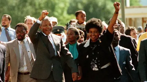 AFP ANC leader Nelson Mandela and wife Winnie raise fists upon his release from Victor Verster prison, 11 February 1990 in Paarl