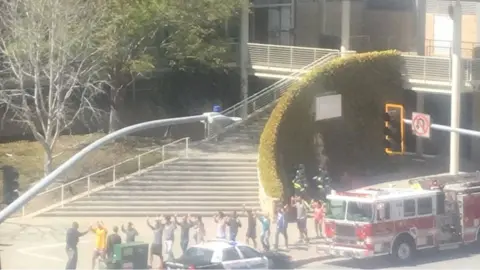 TWITTER/@ERINJEANC/via REUTERS People gather outside a building following a shooting at the headquarters of YouTube, in San Bruno, California, U.S., April 3, 2018 in this picture obtained from social media.