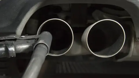 AFP Testing a car exhaust