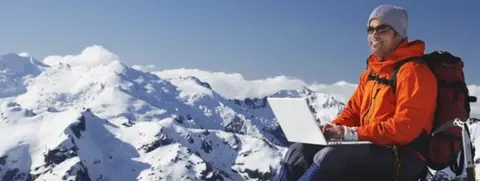 Thinkstock man up mountain with laptop