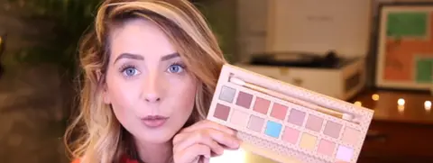 YouTube Screenshot of beauty vlogger Zoella holding an eyeshadow palette