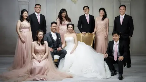 Merwin Adenan A family wearing rose gold-themed wedding outfits