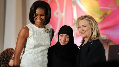 AFP US First Lady Michelle Obama (L) and Secretary of State Hillary Clinton pose with Samar Badawi of Saudi Arabia as she receives the 2012 International Women of Courage Award during a ceremony at the US State Department in Washington, DC, on March 8, 2012