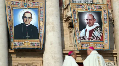 Reuters Pope Paul VI (r) and El Salvador's Archbishop Oscar Romero (l) pictures are seen before a mass for their canonisation at the Vatican
