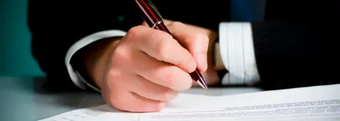 Getty Images Signing contracts