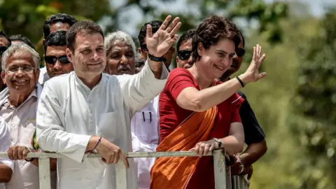 Getty Images Rahul Gandhi and Priyanka Gandhi wave at the crowd in the road show after Rahul Gandhi filing nominations from Wayanad district on April 4, 2019 in Kalpetta town in Wayanand, India.