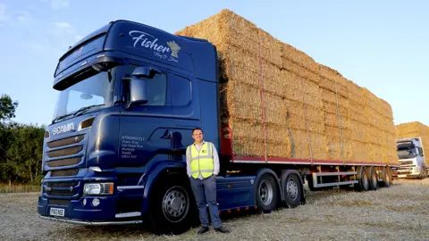 Jack Fisher standing in front of his lorry