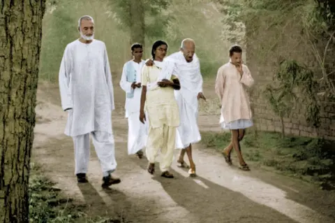 DINODIA Mahatma Gandhi walking with his granddaughter Manu Gandhi and Khan Abdul Ghaffar Khan, Patna, Bihar, India, March 1947