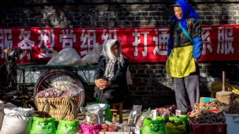 Getty Images Local women sell produce in the market. Zhongyi market, located at the southern gate of Dayan ancient city, in Lijian, Yunnan Province in China