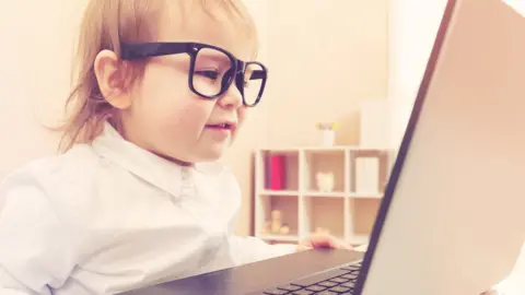 Getty Images/Melpomenem Toddler using laptop