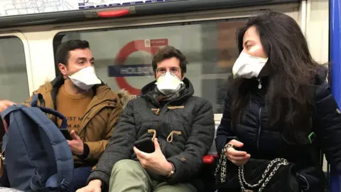 BBC People wearing face masks on the London Underground