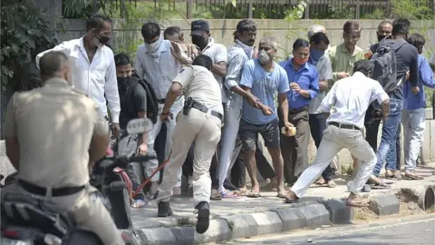 Getty Images Police had to baton charge unruly queues outside liquor shops