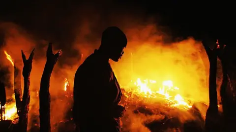 AFP A Sudanese rebel fighter from the Justice and Equality Movement (JEM) sombrely watches the abandoned village of Chero Kasi burn less than an hour after Janjaweed militiamen set it ablaze in the violence plagued Darfur region September 7, 2004.