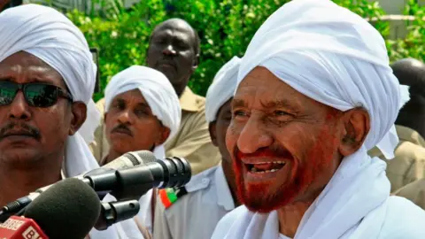 Getty Images Sudanese top opposition leader and former premier Sadiq al-Mahdi addresses worshippers during Eid al-Fitr prayer marking the end of the Muslim holy fasting month of Ramadan on June 5, 2019 in Omdurman, just across the Nile from the capital Khartoum.