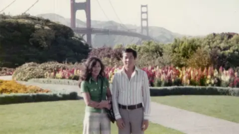 Ted Ngoy Ted and Christy in front of the Golden Gate bridge