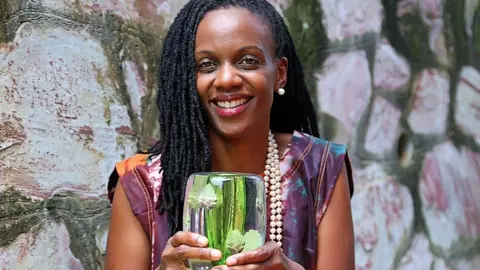 AFrica Food Prize Catherine Nakalembe holding award