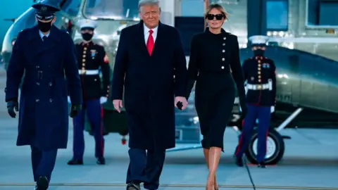 AFP via Getty Images Outgoing US President Donald Trump and First Lady Melania Trump step out of Marine One at Joint Base Andrews