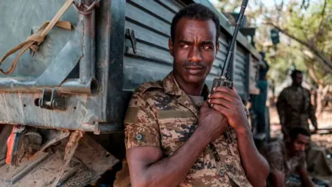 AFP An Ethiopian soldier stands with a walkie talkie in his hand at the 5th Battalion of the Northern Command of the Ethiopian Army in Dansha, Ethiopia, on November 25, 2020