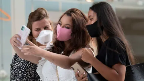 Getty Images Group of women taking a selfie