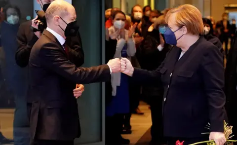 EPA German Chancellor Olaf Scholz says goodbye to former German Chancellor Angela Merkel after the official handing over ceremony of the Chancellery in Berlin, Germany, 08 December 2021