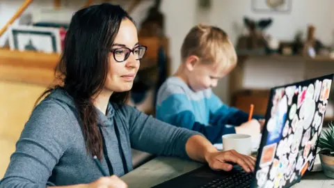 Getty Images Stock shot of women working from home with a child