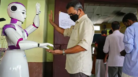 Getty Images Robot dispenses hand sanitiser in Kochi