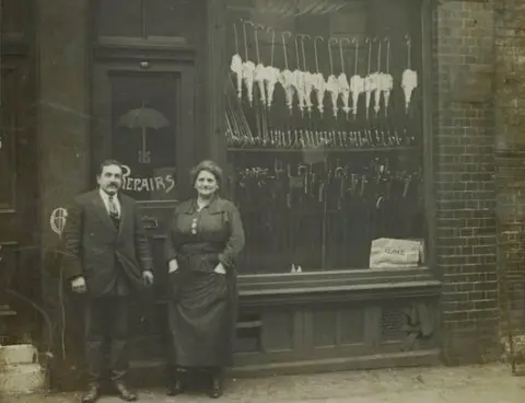 Museum of London JH & M Fischer outside their umbrella shop, Spitalfields, 1919