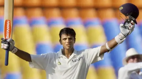 Getty Images Indian Cricketer Rahul Dravid celebrates his century (100 runs) during the first day of the first Test match between India and New Zealand in Ahmedabad, 08 October 2003.