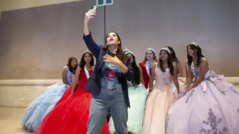 Harness America Ferrera taking a selfie with a group of 'quinceañeras'