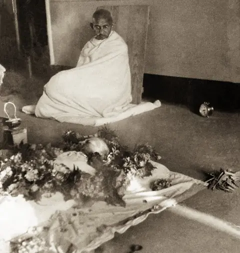 Gandhi looking at Kasturba after she passed away in February 1944