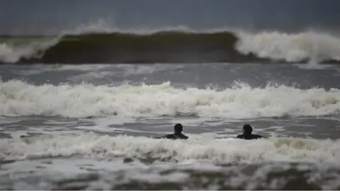 Reuters Surfers in the sea off the Irish Republic