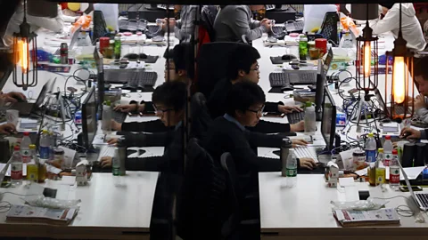 Tomohiro Ohsumi/Bloomberg/Getty Images Workers reflected in a glass door inside Tech Temple, a co-working space for start-ups in Beijing (Credit:Tomohiro Ohsumi/Bloomberg/Getty Images)