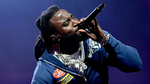 Getty Images Shaboozey performing, holding a microphone to his mouth (Credit: Getty Images)