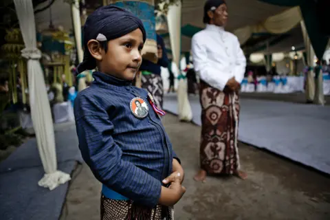 Getty Images Yogya boy wearing campaign image of the Queens bid for the senate.