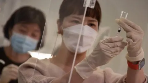 EPA Medical workers practice during a training to give COVID-19 vaccine shots at a training facility of the Korean Nurses Association in Seoul, South Korea, 17 February 2021.