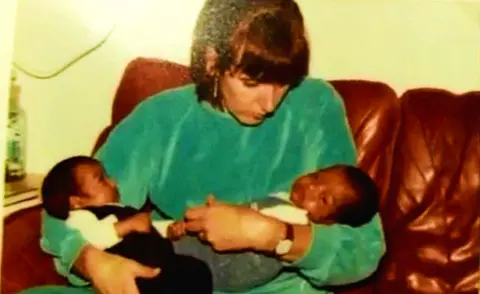 Handout Nimal Samantha (R) with his twin brother, Djoeri Sanjeewa, and their adopted mother