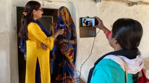 BBC Nazni Rizvi (left) and Meera Devi (right) doing an interview