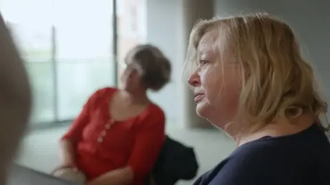 Bristol Women's Voice Fiona at a table talking to members of DWTA