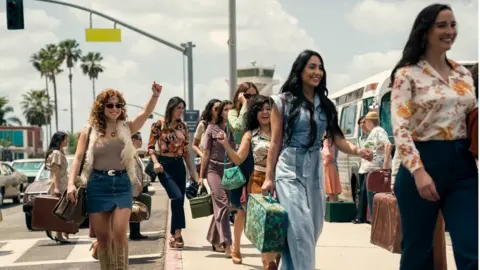 Netflix A scene out of the Netflix series showing women arriving off a bus in Miami